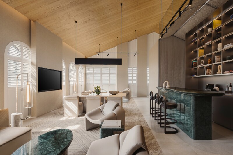 A Shophouse Suite at the Mondrian Singapore Duxton with wood ceilings, large seating area, and bar counter