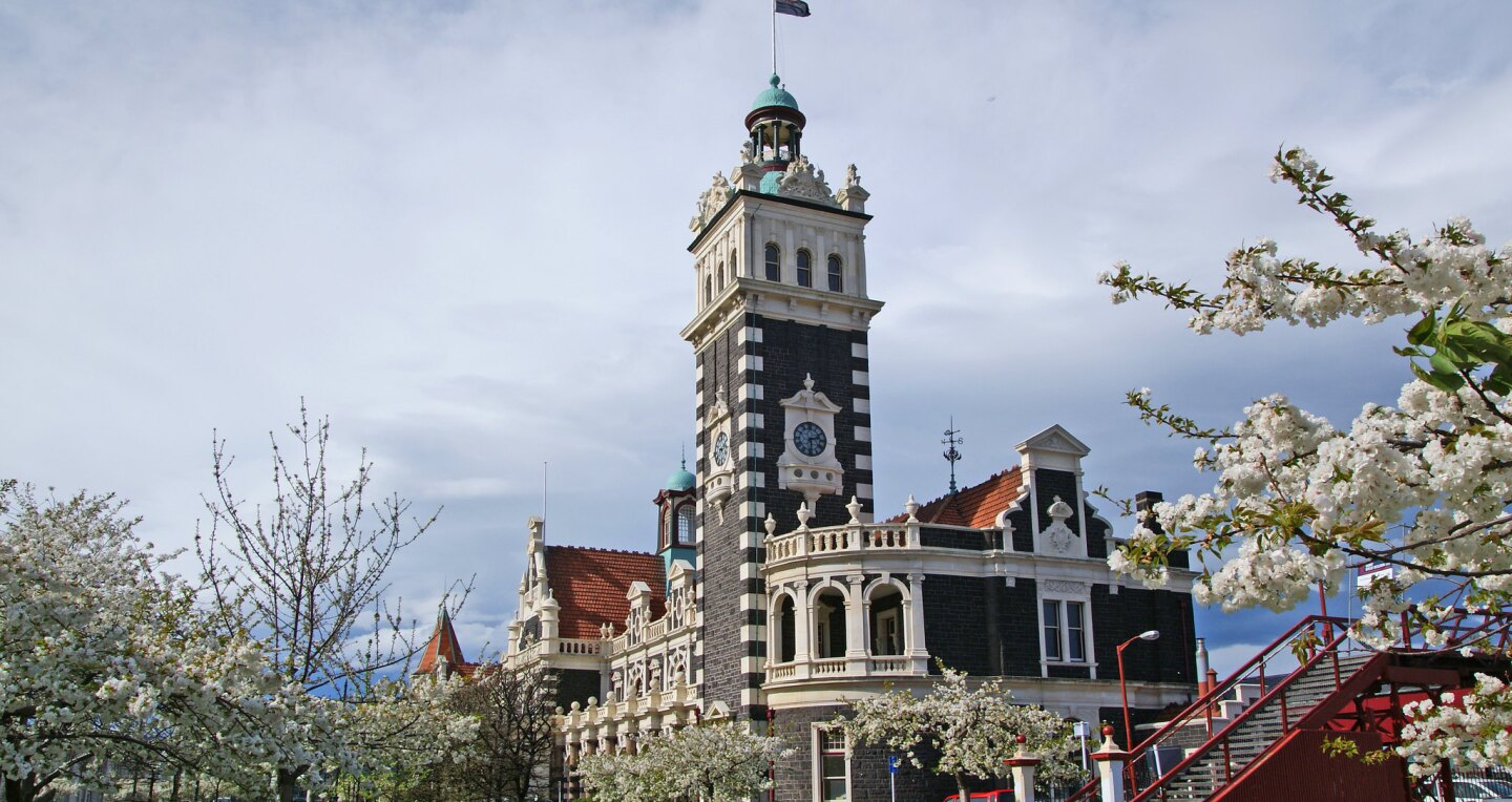 A vintage train station with a tall clock tower