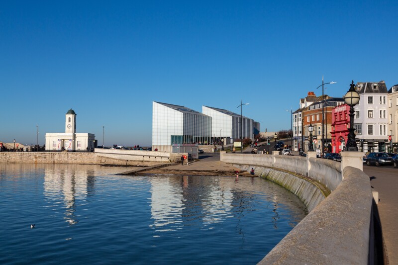 Attractive view across the harbour towards the Turner Contemporary art gallery on the Harbour Arm with clear blue sky behind