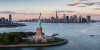 Aerial view of city with Statue of Liberty at sunset