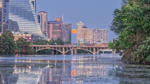 A harvest moon rising over Lady Bird Lake in Austin, Texas