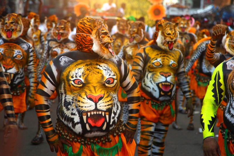 Men painted for the tiger dance during the Onam festival
