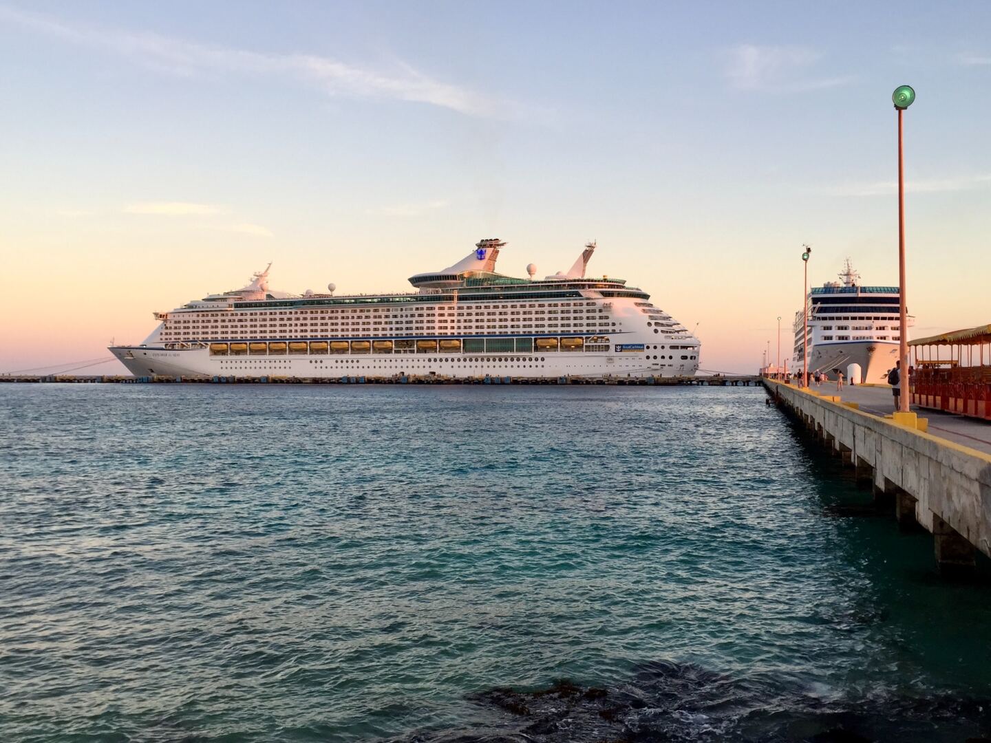 Two large cruise ships near pier
