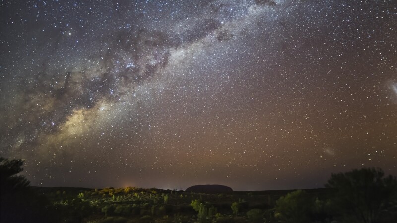 Silvery-gray Milky Way running diagonally over Uluru