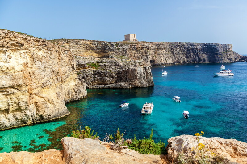 Translucent aqua waters meet dramatic cliffs in Comino.
