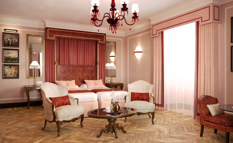 A guest room at Hotel d'Inghilterra with wood floors and wingback chairs in a white, beige, and red color scheme