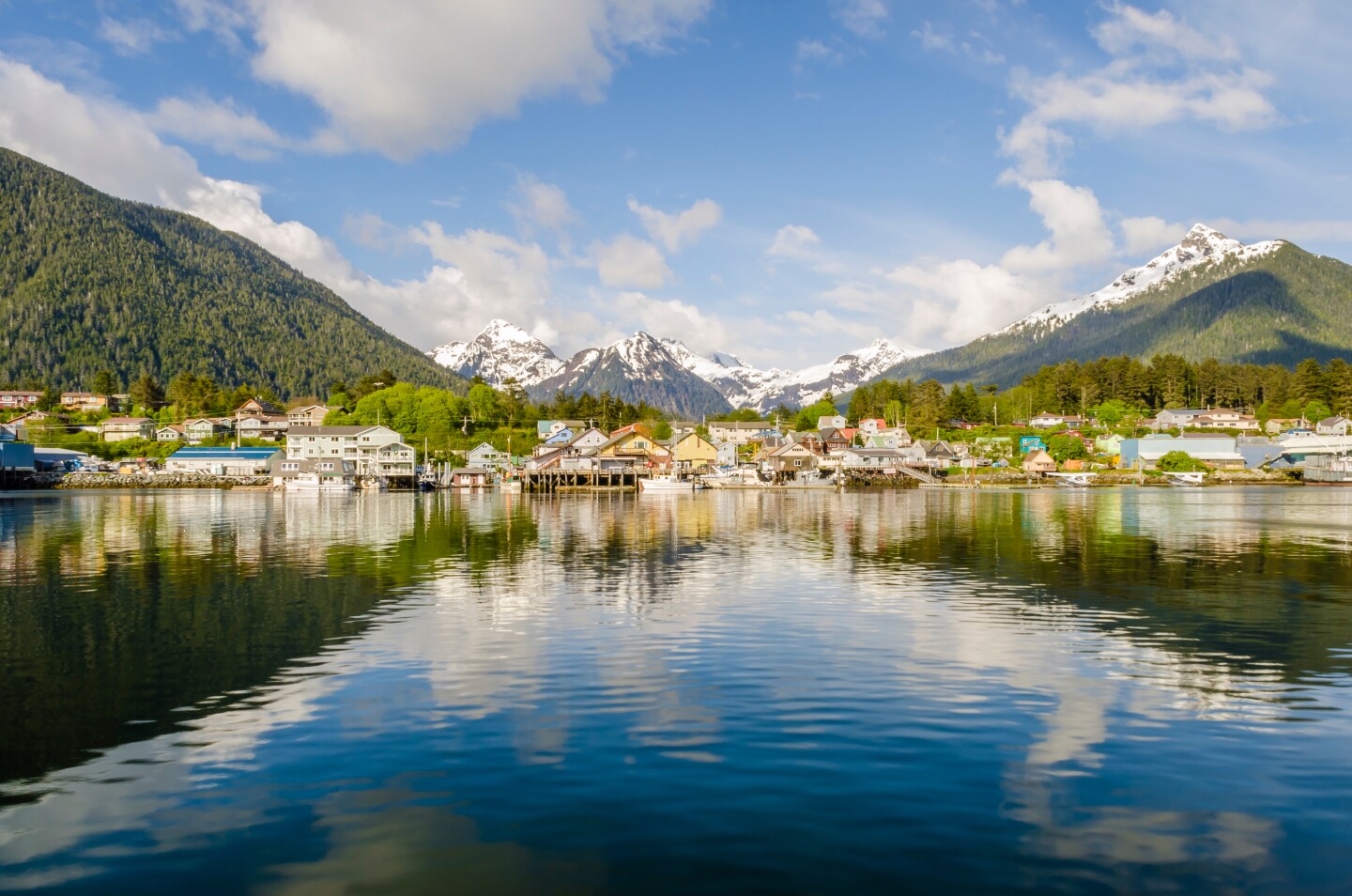 The town of Sitka viewed from the water with snowcapped mountains in the background