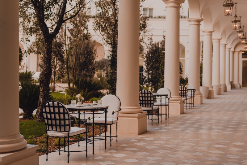 The interior gardens feature covered peristyle walkways.