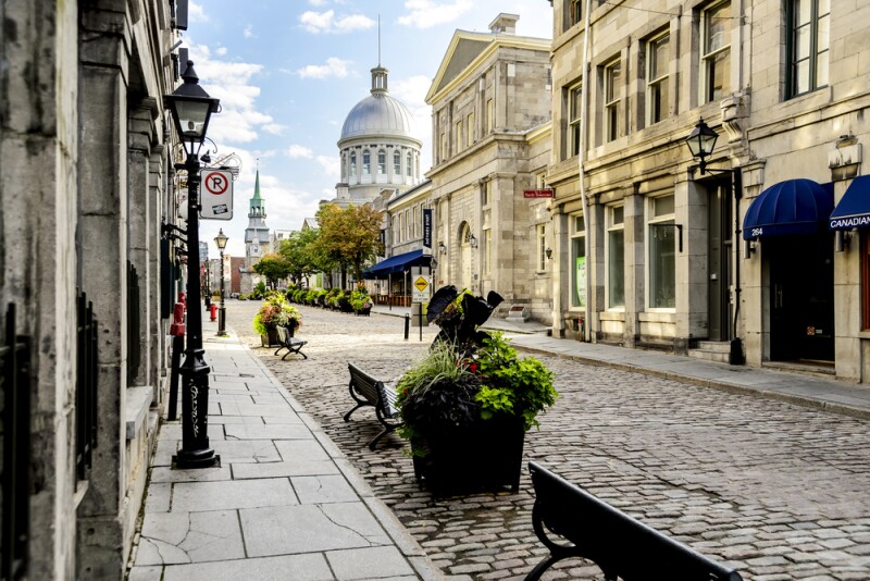 A cobbled street in Old Montreal, with benches