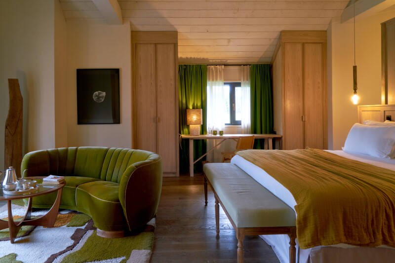 Interior of guest room at Les Sources de Cheverny, with curved green sofa