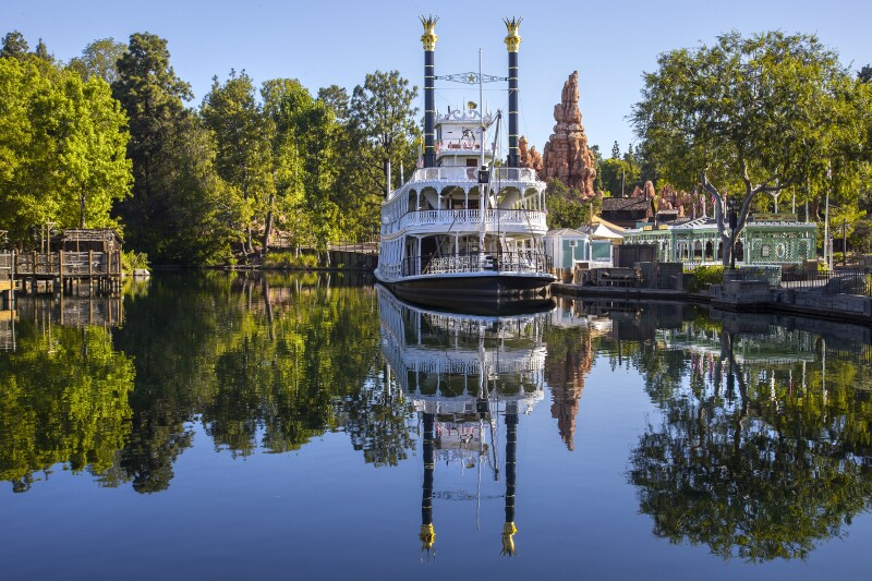 The Mark Twain Riverboat departs from a dock outside Big Thunder Mountain.