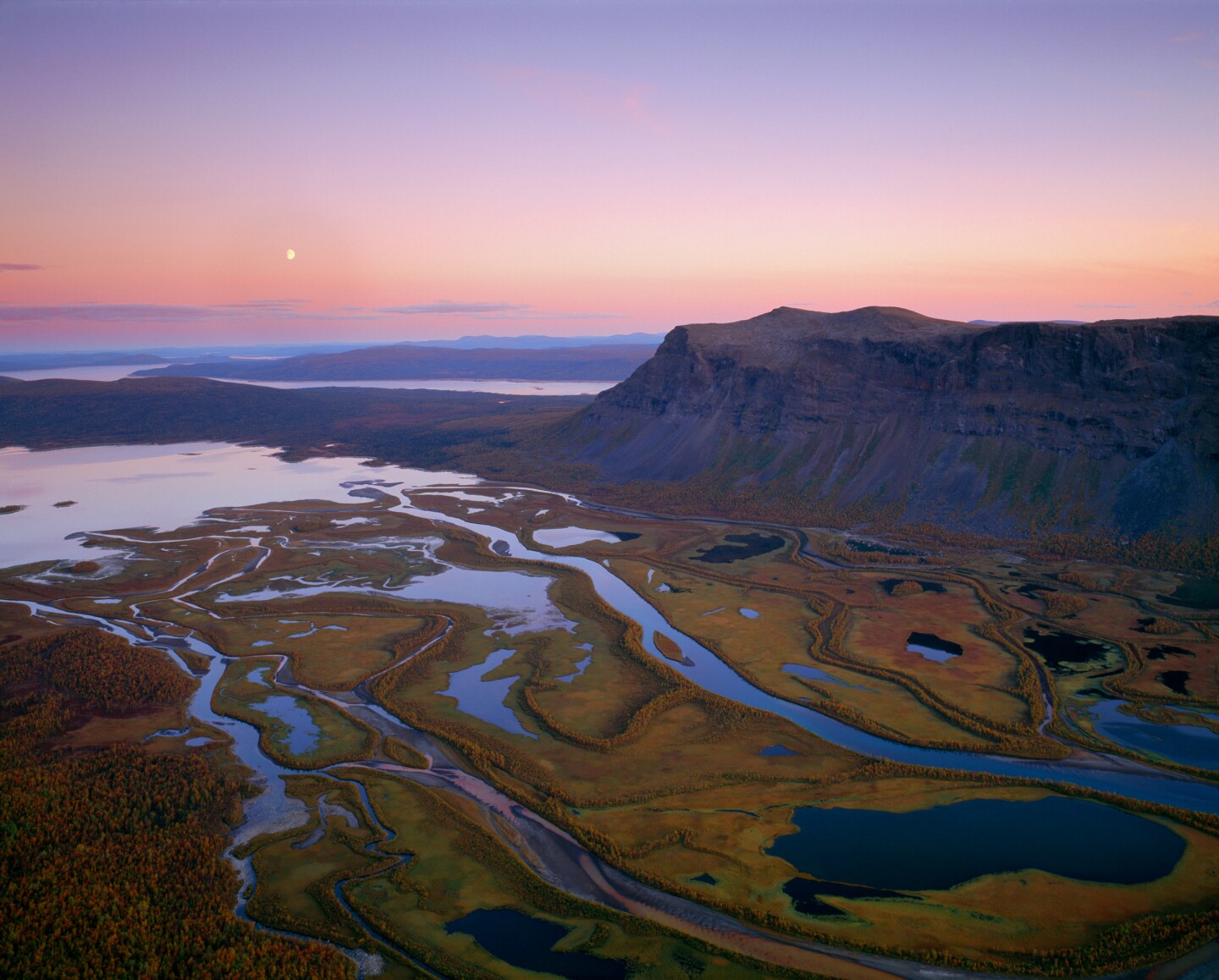 A birds eye view of rivers and mountains at sunset in Sarek National Park, Sweden