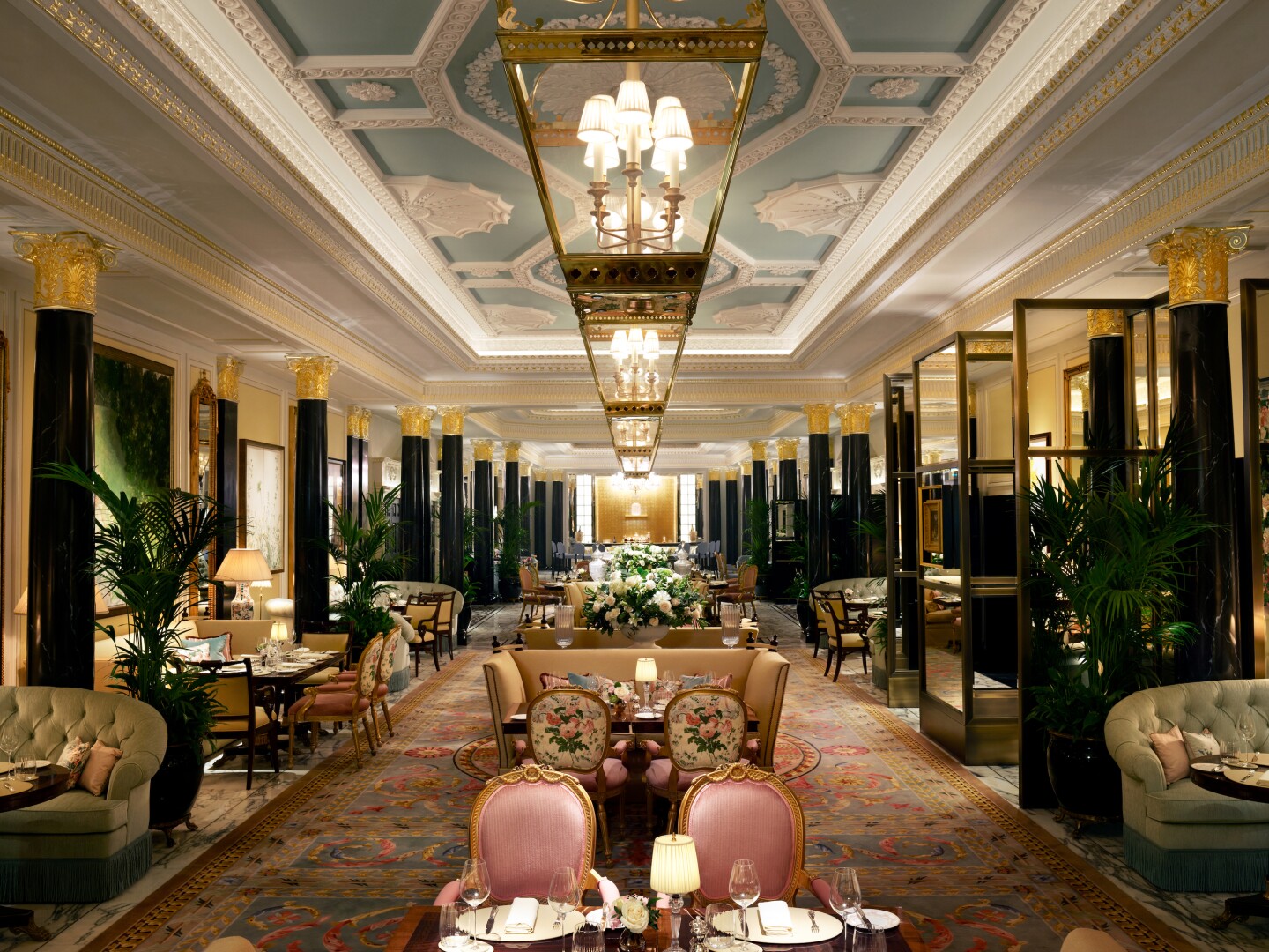 The Dorchester's renovated Promenade, lined with sofas and tall, black gilt-topped columns