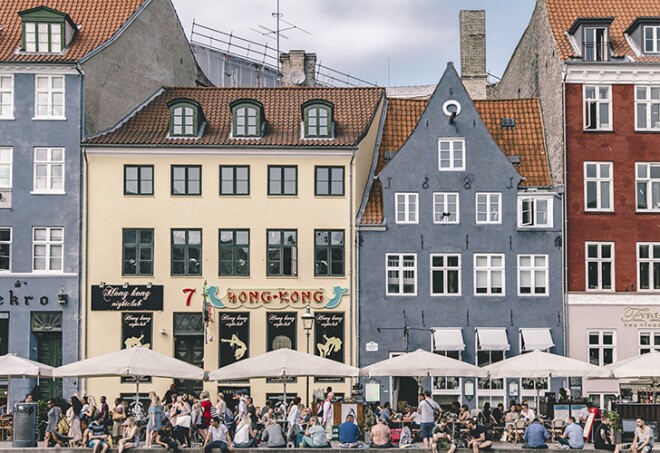 Especially during summer Nyhavn is the perfect place to end a long day. Have dinner at one of the cosy restaurants or do like the locals and buy a beer from a nearby store and rest your feet at the quayside.
Nyhavn was originally a busy commercial port where ships from all over the world would dock. The area was packed with sailors, ladies of pleasure, pubs and alehouses.
Today the beautiful old houses have been renovated and classy restaurants dominate the old port. Nyhavn is filled with people enjoying the relaxed atmosphere by the canal, jazz music and great food. 
No. 9, Nyhavn, is the oldest house in the area dating back to 1681. The design of the house has not been altered since that time.
Many of the houses lining the quays of Nyhavn have been the homes of prominent artists.