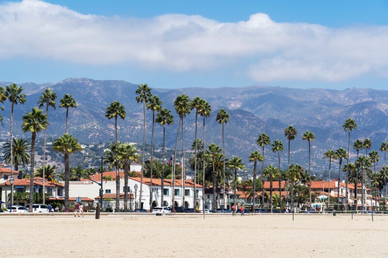 The city of Santa Barbara with mountains and palm trees.