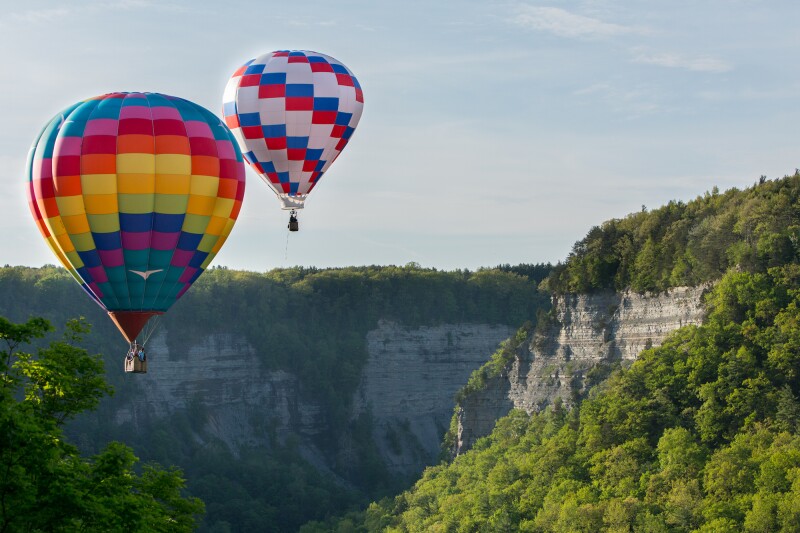 During the “Red, White & Blue Balloon Rally” every May, onlookers watch as balloons float above Letchworth State Park.