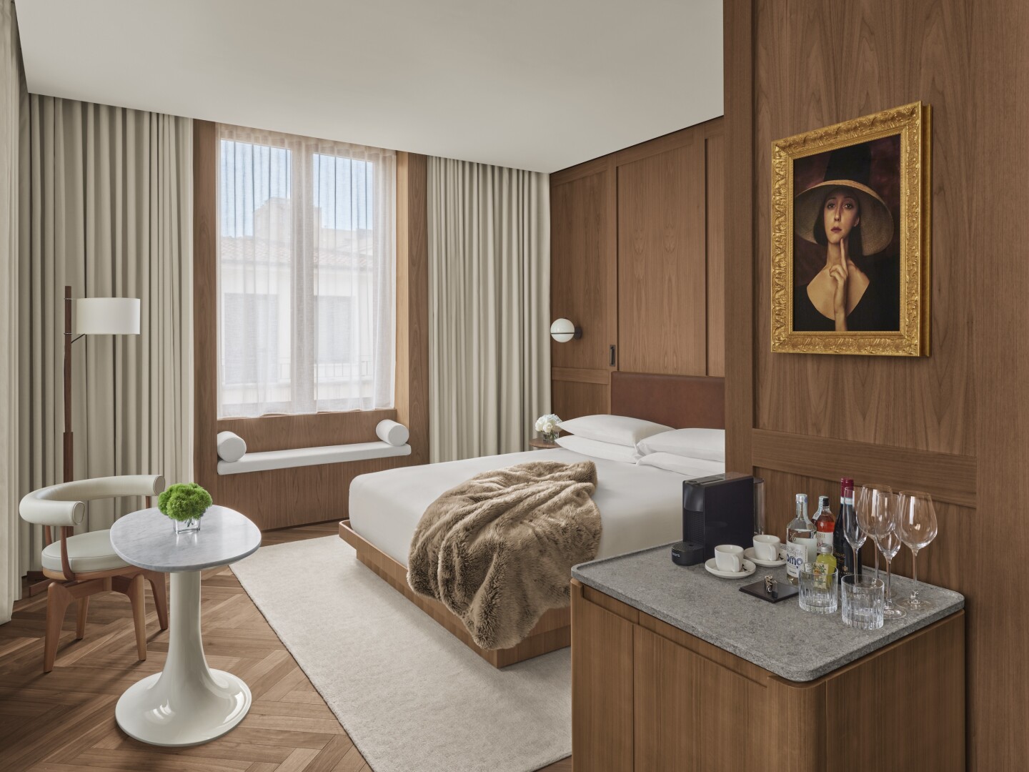 Guest room at the Edition Rome, with hardwood floors and modern white furnishings 