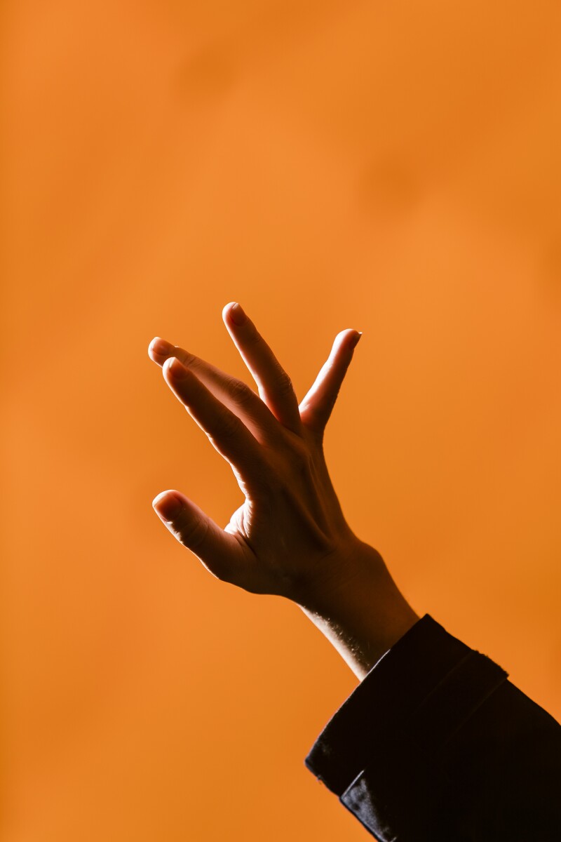 A member of the simulation crew uses a hand to shield her eyes from the bright desert sun inside a inflatable dome used to conduct various experiements