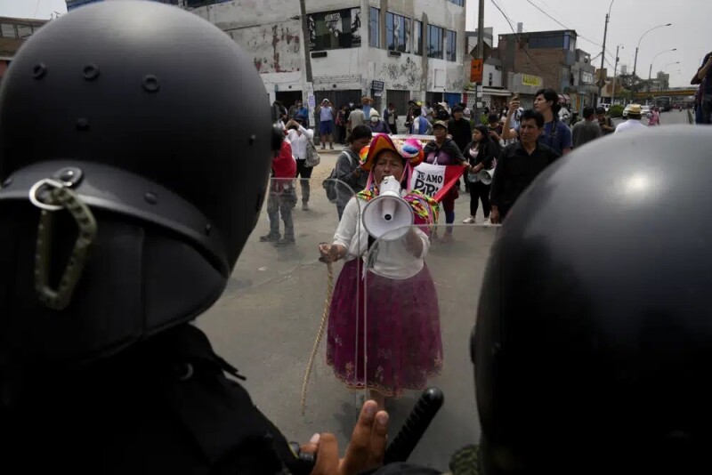 An antigovernment protester challenges police at the San Marcos University in Lima, Peru<br/>