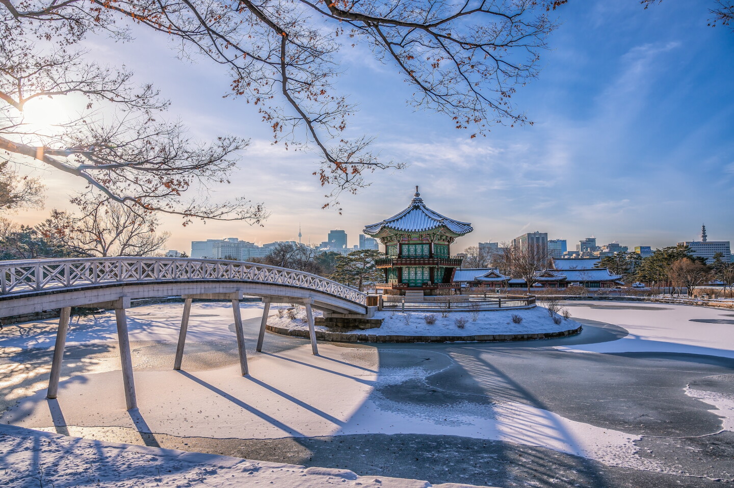 A dusting of snow all around the Gyeongbokgung Palace, Seoul, with pedestrian bridge crossing over water