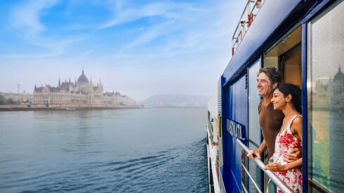 A couple looking out at Budapest from a cruise ship