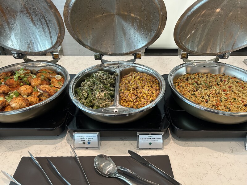 Three silver bowls filled with food at buffet of Delta Sky Club Lounge, JFK, Terminal 4, Concourse A
