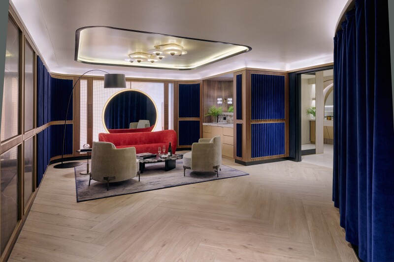 Lounge suite with sitting area with blue velvet drapes and a bathroom off to the side