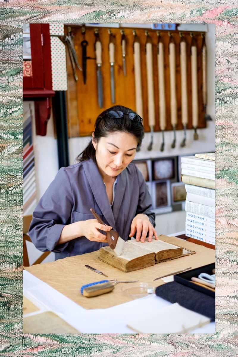 Michiko Kuwata, co-owner of AtelierGK Firenze in Florence, prepares a Latin- Italian dictionary for restoration.