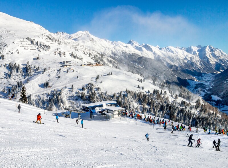 Skiers and snowboarders on the slopes of winter resort St. Anton in Austria