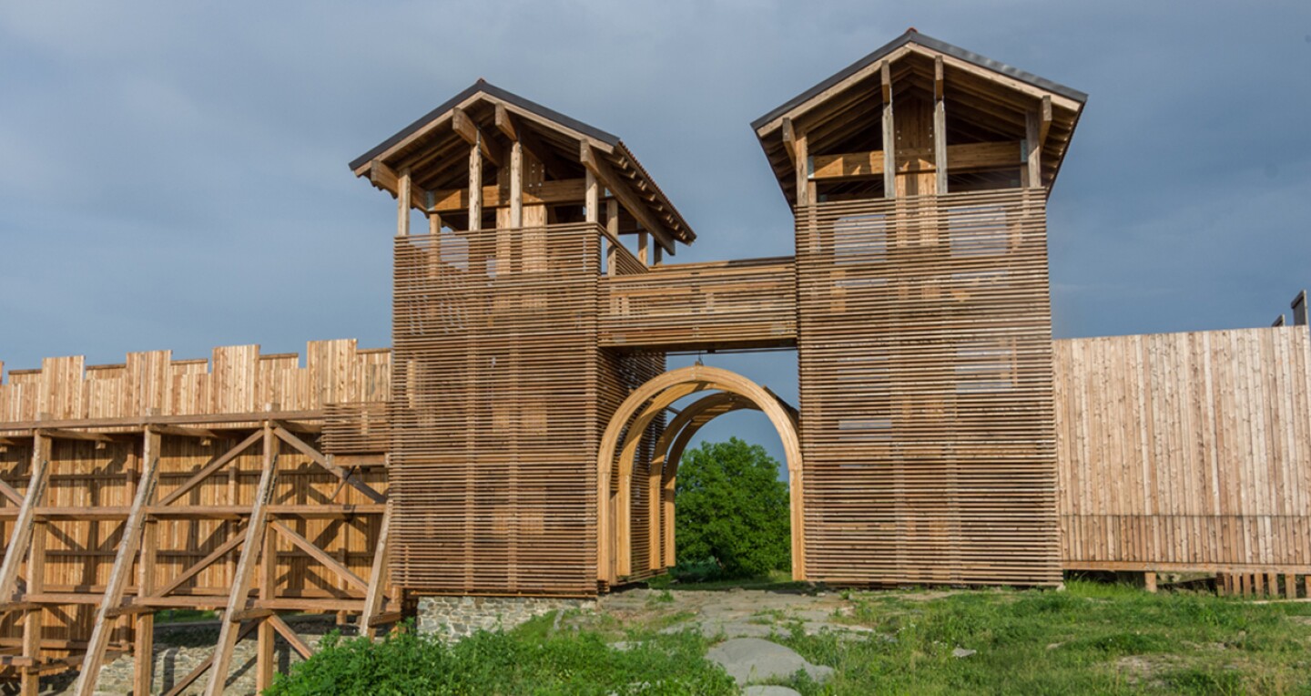 A wooden wall with an arch doorway