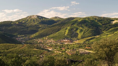 Park City sits in the valley between lush, green covered mountains.