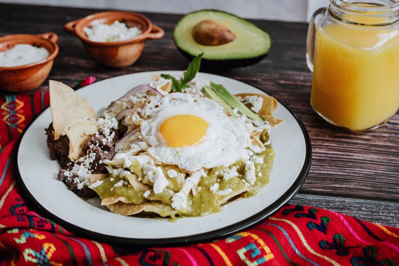 Chilaquiles with orange juice and avocados.