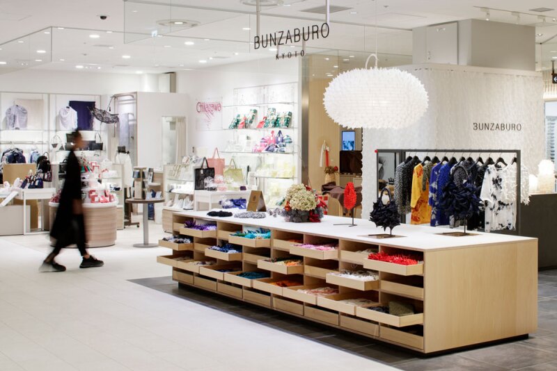 Large, low wood cabinet of drawers displaying merchandise at the Bunzaburo store