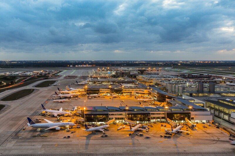 Aerial view of George Bush Intercontinental Airport in Houston with numerous airplanes parked at airport gates
