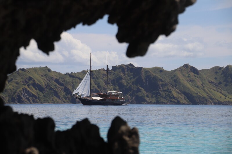 Sailing yacht in Indonesia with island in background