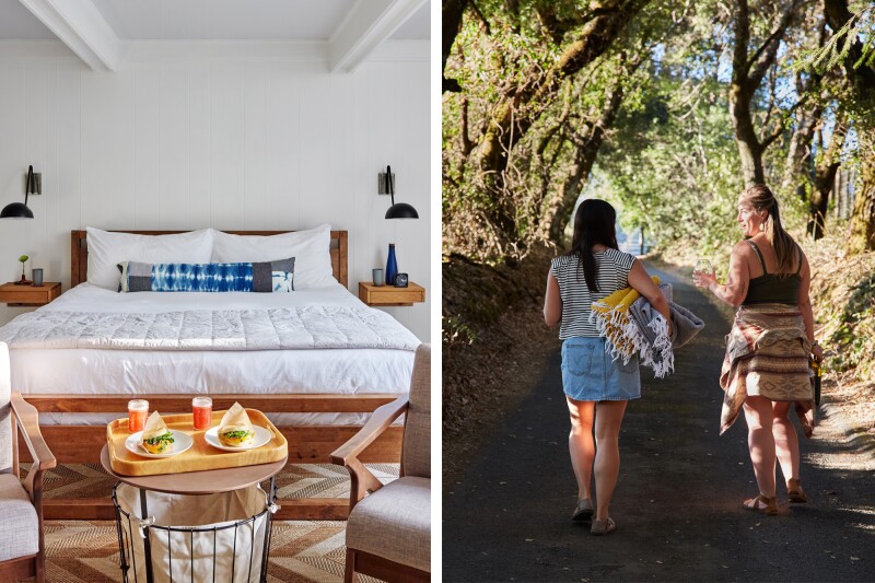 White guest room, with tray of snacks on small table at foot of bed