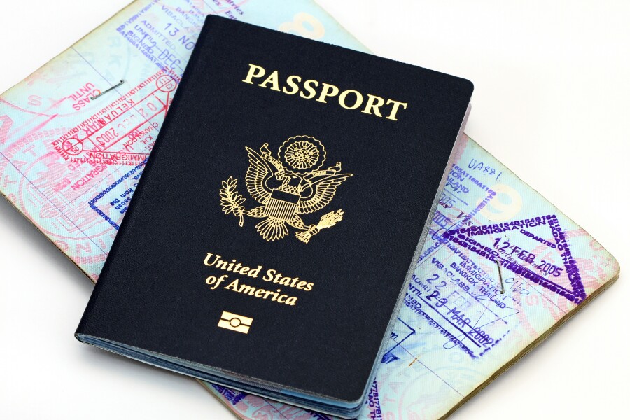 U.S. passport on top of open passport with stamps