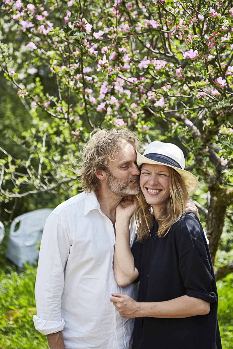 Flemming Hansen and Mette Helbæk serve food raised on their permaculture farm to guests.
