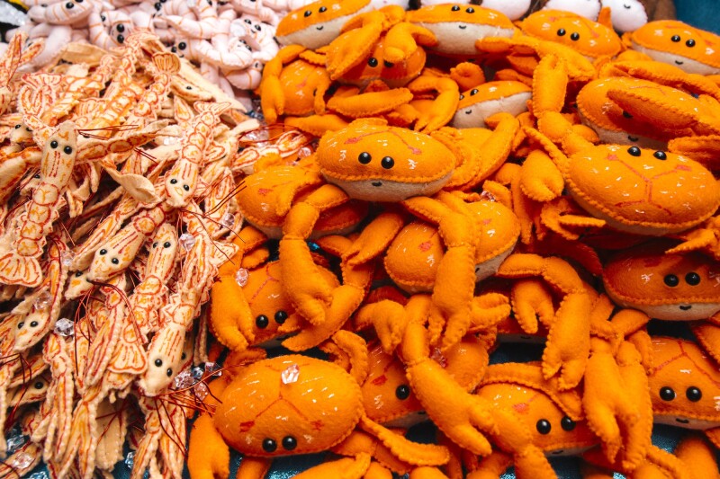 British artist Lucy Sparrow adorned each object with tiny eyes and smiles to encourage viewers to consider their relationship with food and consumerism.