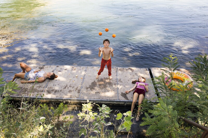 'Circus love' - Les Pêcheurs de Rêves. Chapter 2
Avignon, France 2017.
Zoran 10 and Zia 13 travel with their family during festivals and performances all over Europe. Their parents own a small family Circus called 'Les Pêcheurs de Rêves'. Zoran is Juggling, while his sister and a friend are resting on the river.
© Stephanie Gengotti
