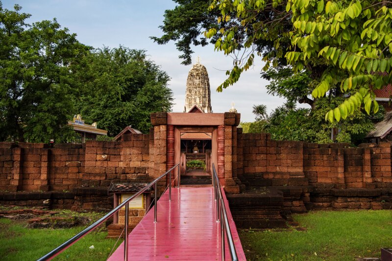 A red ramp leading up to a doorway at Wat Mahathat Buddhist temple in Thailand