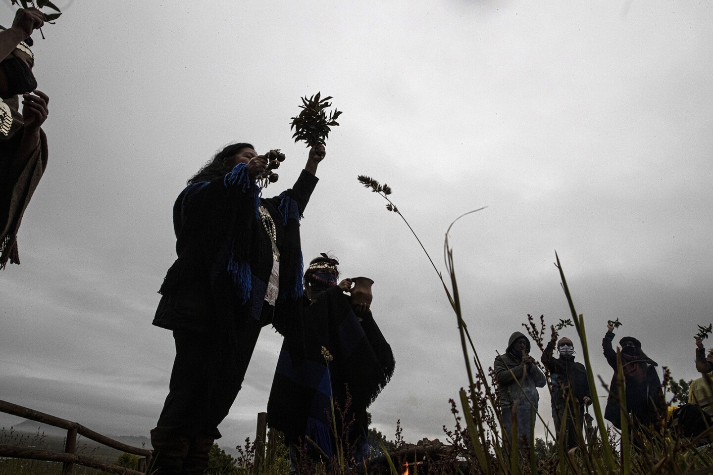 Mapuche Indigenous people take part in a ritual during a total solar eclipse in Carahue, La Araucania, Chile.