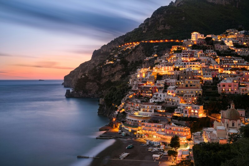 Positano coast line with colorful light up buildings at dusk