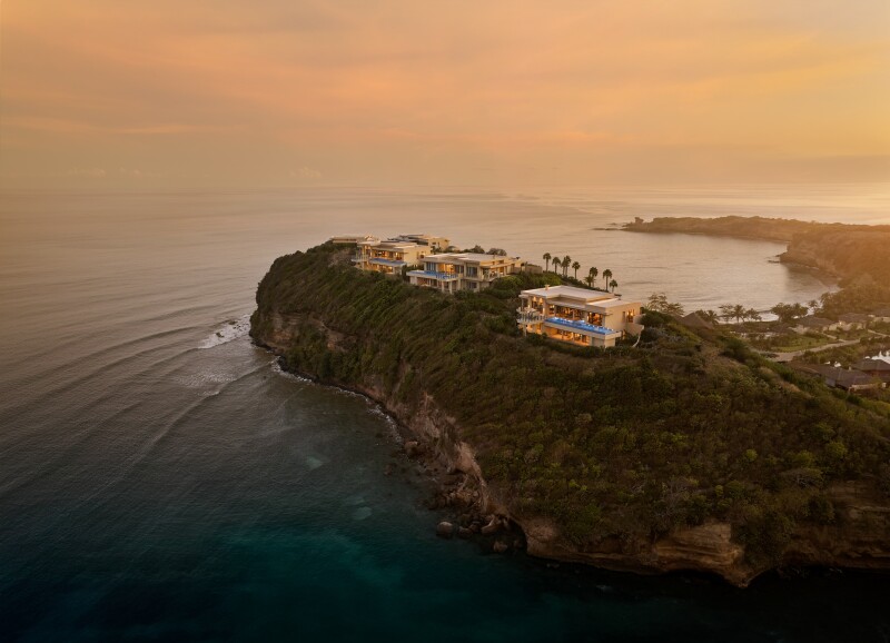 Aerial view of at Six Senses La Sagesse atop rocky cliffs, with sea on three sides