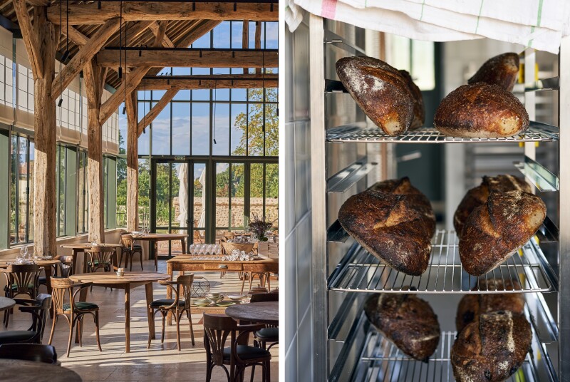 Empty seating in wood-beamed room with glass walls (left); a few loaves of bread on tiered metal racks at Le Doyenné (right)