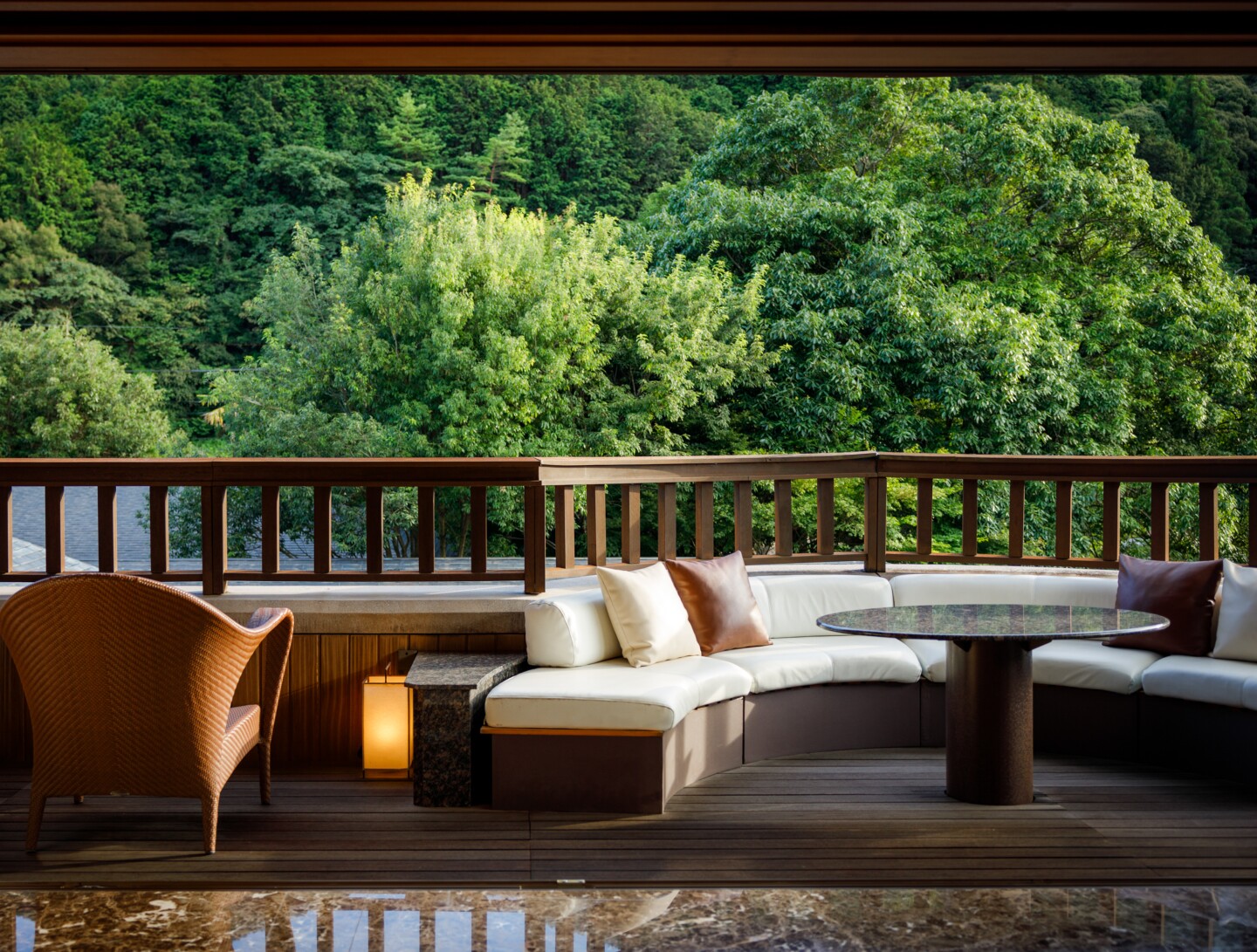 Wood deck with white cushioned seats overlooking forest