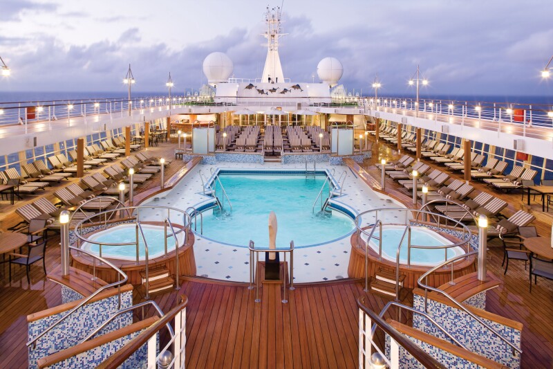 "Seven Seas Voyager" pool deck surrounded by many empty lounge chairs