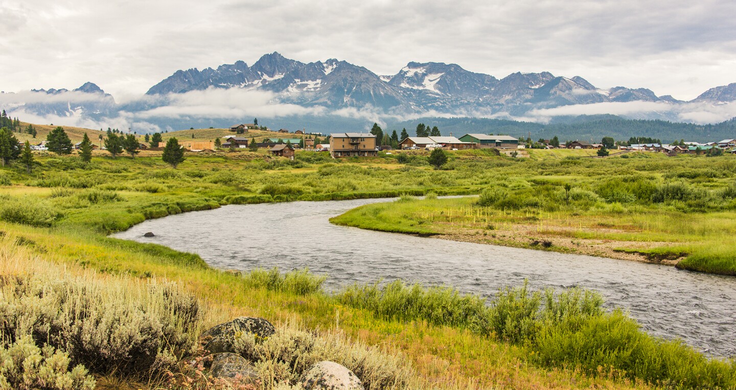 Stanley, Idaho with Valley Creek in the foreground and Sawtooth Mountains beyond.