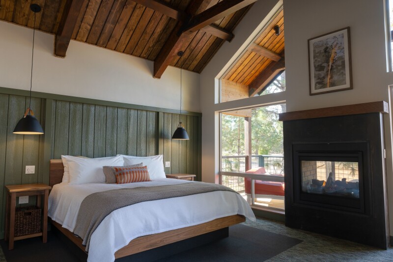 Cabin interior, Firefall Ranch, with high wood ceiling and indoor/outdoor fireplace