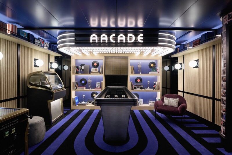 Game room with blue-and-black striped carpets, arcade sign, and jukebox